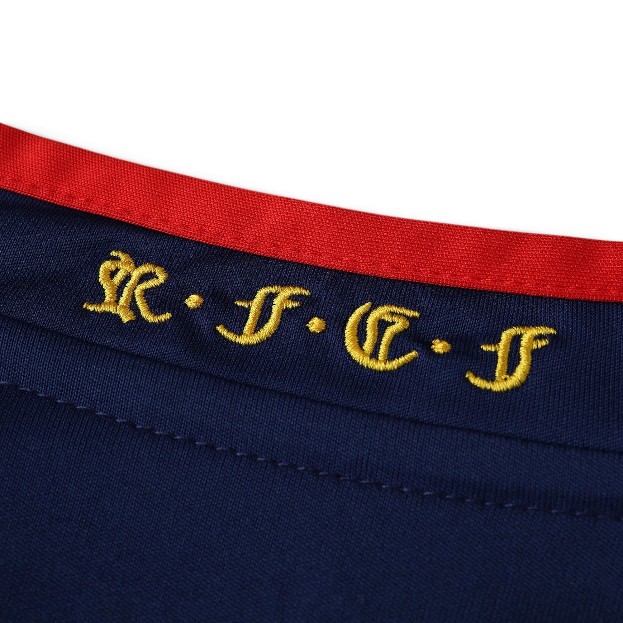 Elite Retro Kits Spain 2010 World Cup final away shirt featuring navy blue fabric with gold RFEF embroidery and red trim