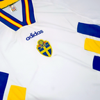 Elite Retro Kits Sweden 1994 away football shirt in white with blue and yellow diagonal blocks and striped collar.