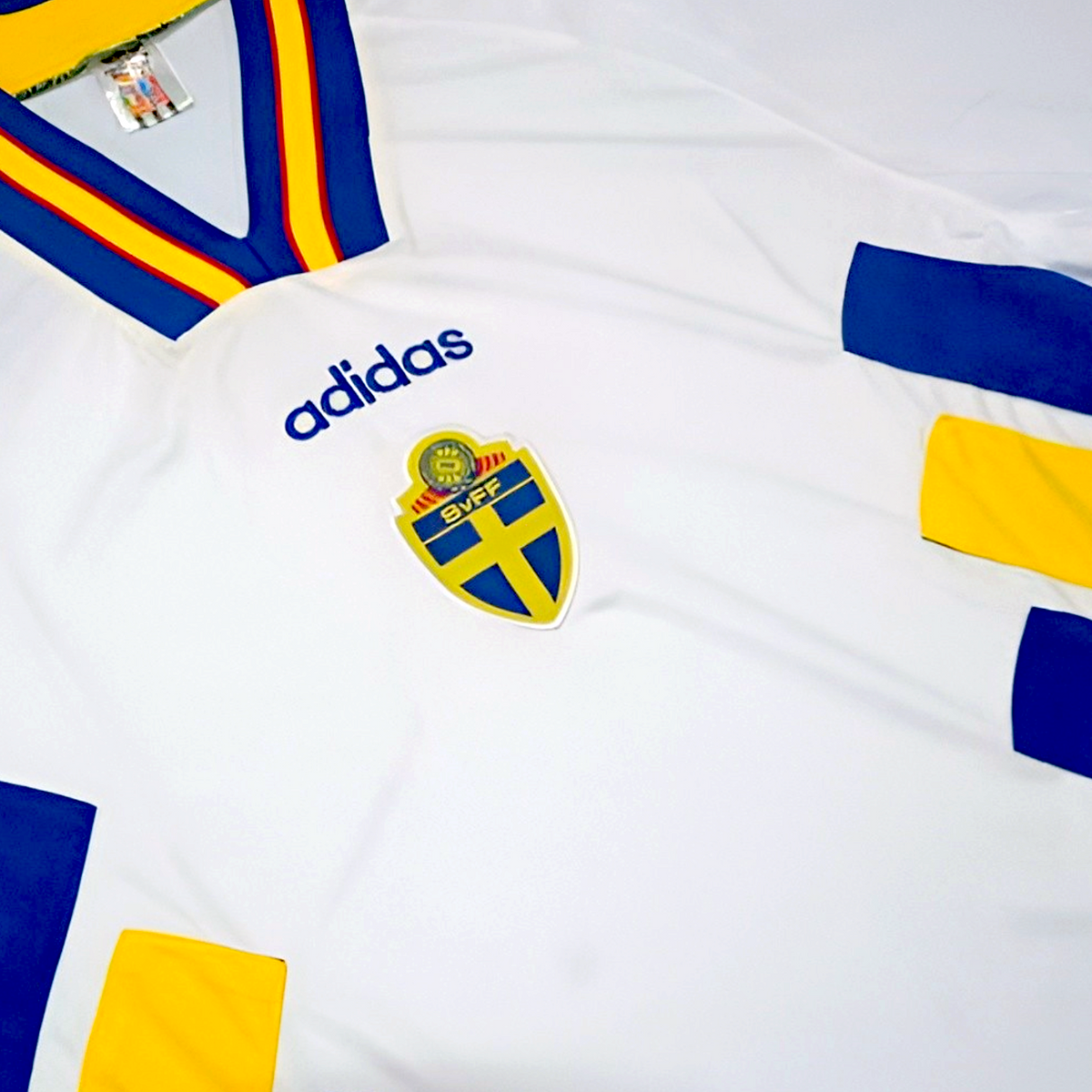 Elite Retro Kits Sweden 1994 away football shirt in white with blue and yellow diagonal blocks and striped collar.