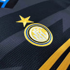 Close-up of a sports team logo on a dark background with yellow accents