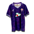 A vintage soccer jersey in purple with a geometric pattern, featuring the original Lotto logo, a collar, and 7UP sponsor branding.
