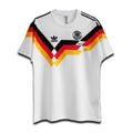 A vintage white football jersey with black, red, and gold stripes, featuring the Adidas logo and the Germany national team emblem.