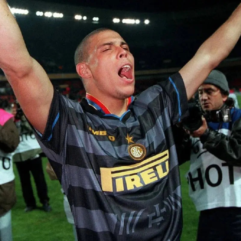 Ronaldo wearing an Inter Milan jersey celebrating on a soccer field with Pirelli logo.