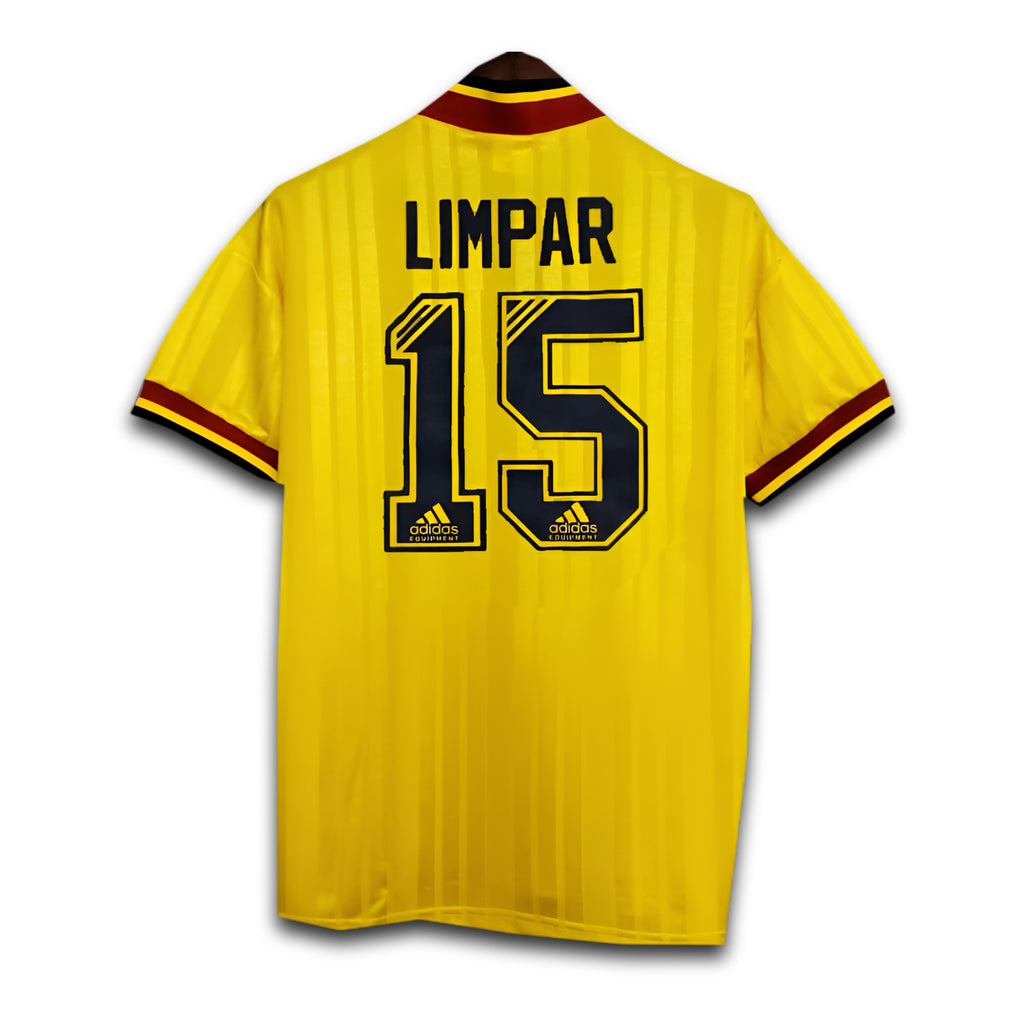 Yellow Arsenal shirt with JVC Adidas sponsoring and Blue stripes and 'LIMPAR' and number '15' on a white background