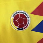 Colombian football federation logo on a yellow background