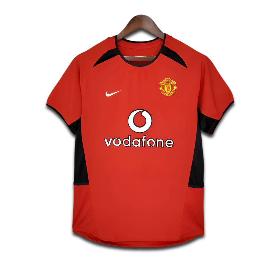 Red sports jersey with black accents on a hanger, featuring Vodafone and Nike logos.