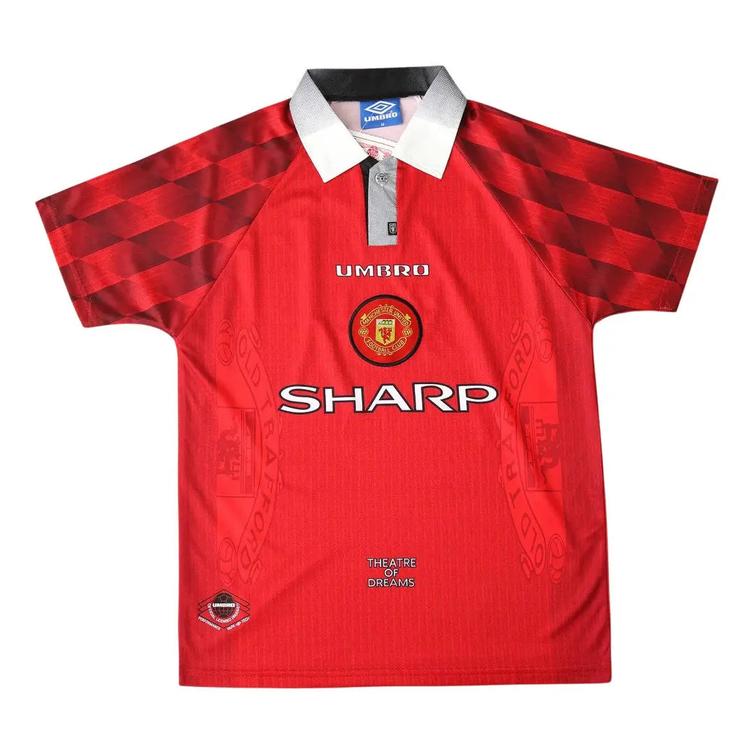 A red Manchester United short-sleeve soccer jersey with a white collar, featuring the Umbro logo, Manchester United crest, and Sharp sponsor logo on the front.