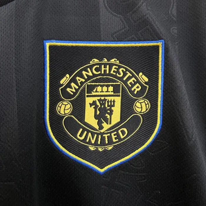 Manchester United logo on a black background