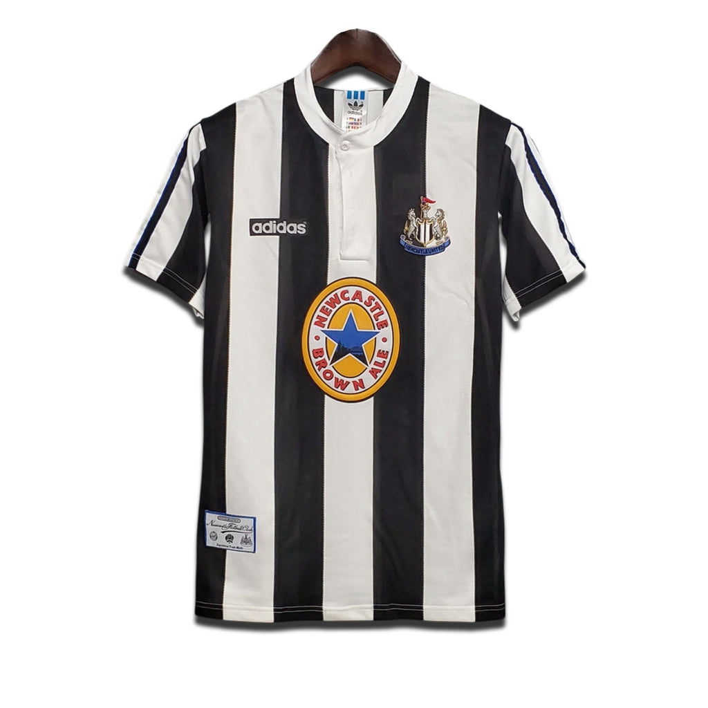 A classic Newcastle United FC home shirt featuring black and white stripes with the Adidas logo and Newcastle Brown Ale sponsor.