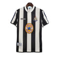 A classic Newcastle United FC home shirt featuring black and white stripes with the Adidas logo and Newcastle Brown Ale sponsor.