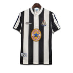 A classic Newcastle United FC home shirt featuring black and white stripes with the Adidas logo and Newcastle Brown Ale sponsor.
