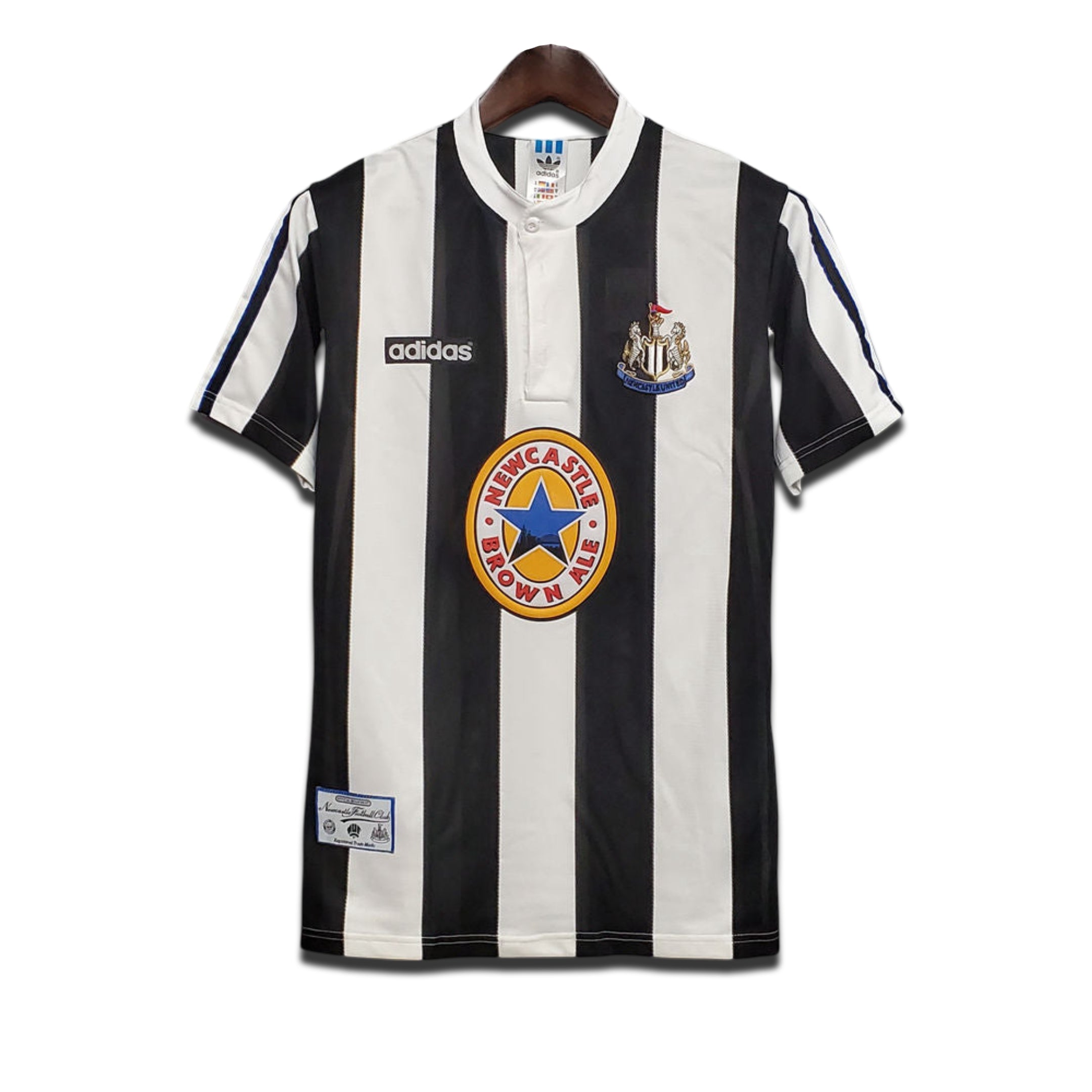 A classic Newcastle United FC home shirt featuring black and white stripes with the Adidas logo and Newcastle Brown Ale sponsor.