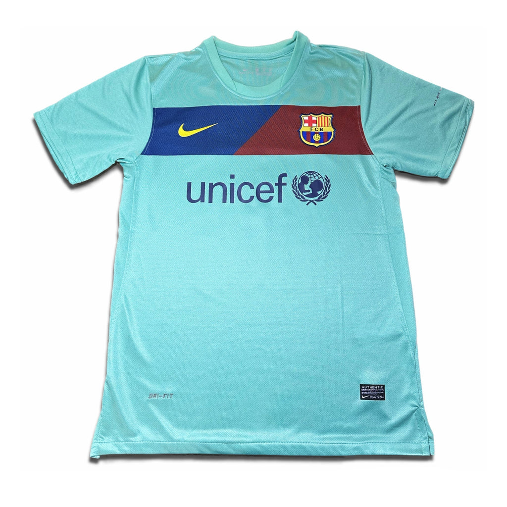 A blue short-sleeved soccer jersey with a red and white bar on the chest, featuring the Barcelona FC crest and the UNICEF logo, with a Nike logo at the top.