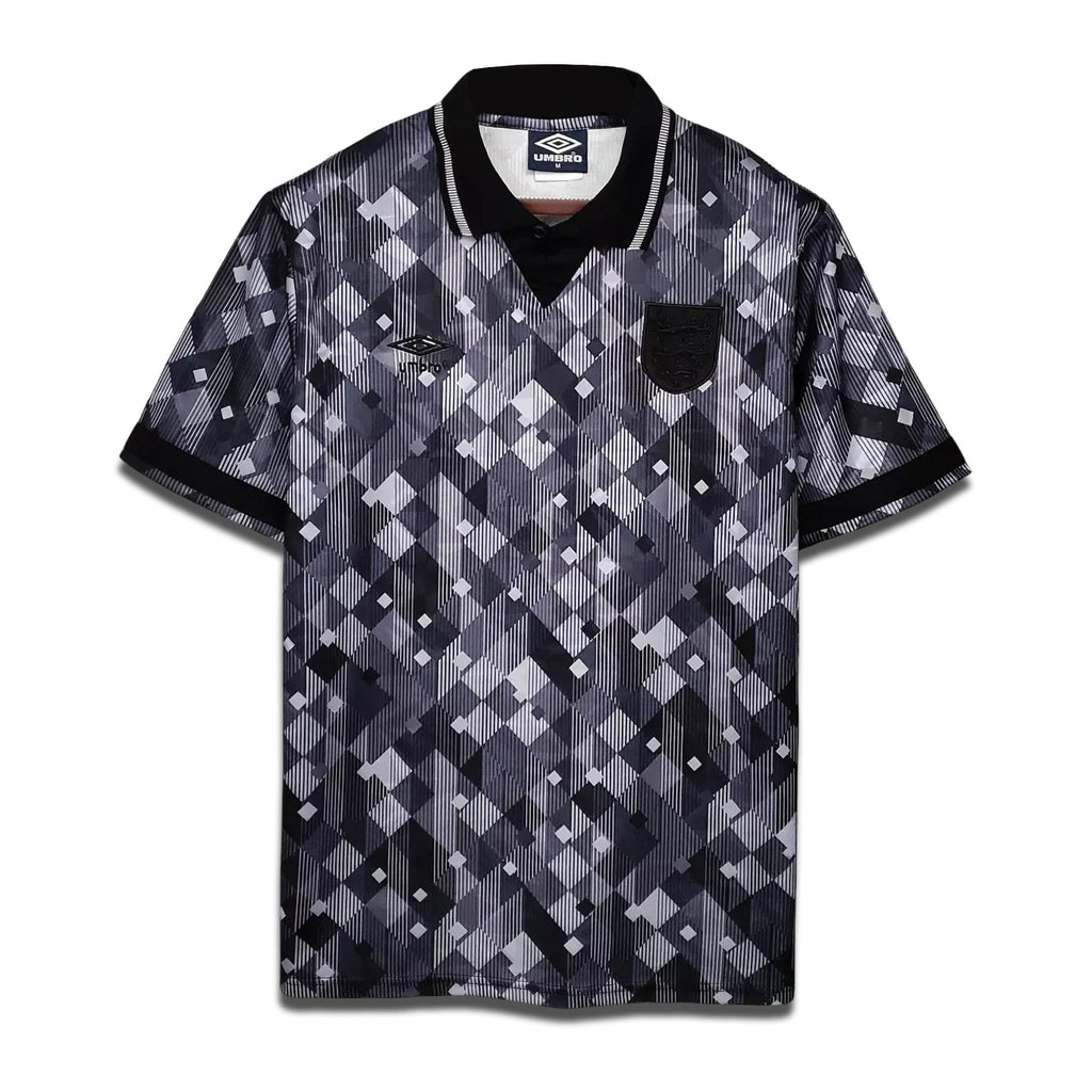 A retro black and white geometric patterned soccer shirt from England's 1990 Season with a collar and short sleeves.