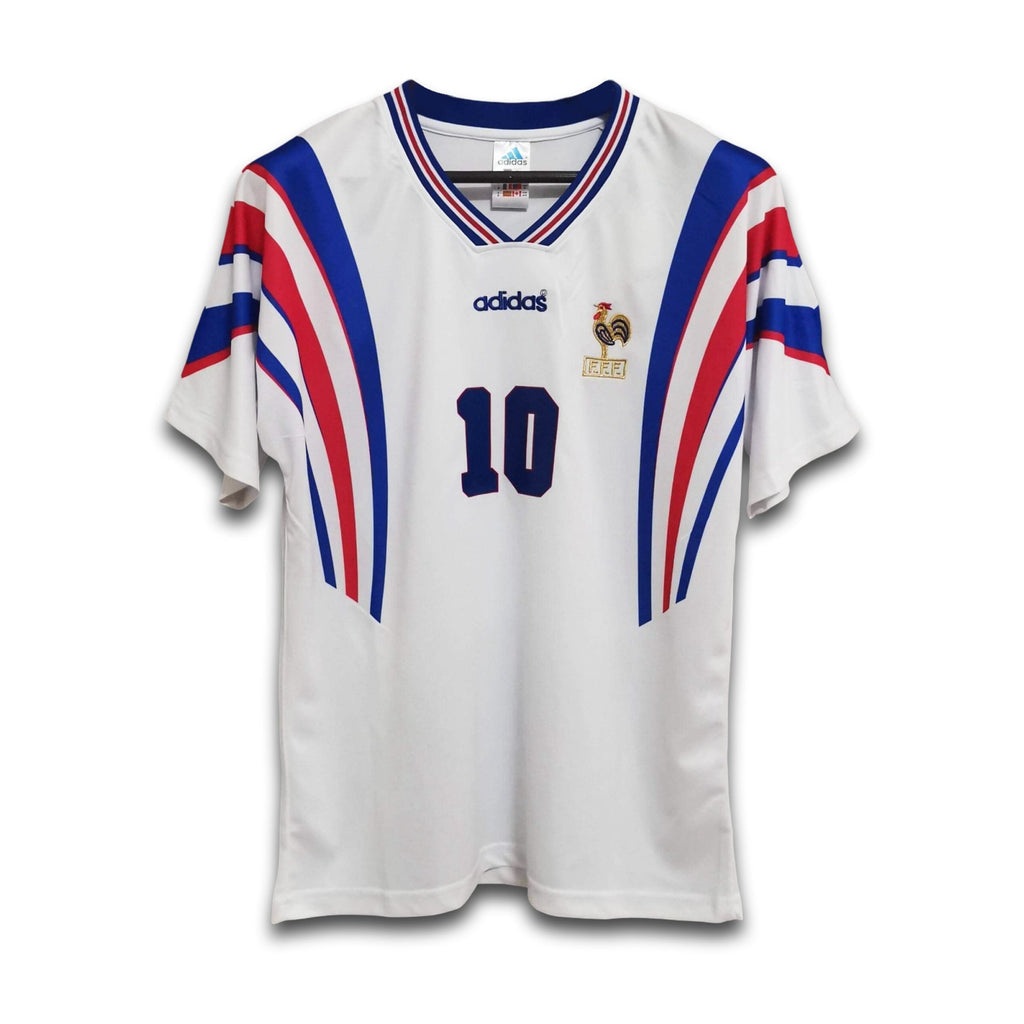 A white football jersey with blue and red accents and the number 10 visible on the front.
