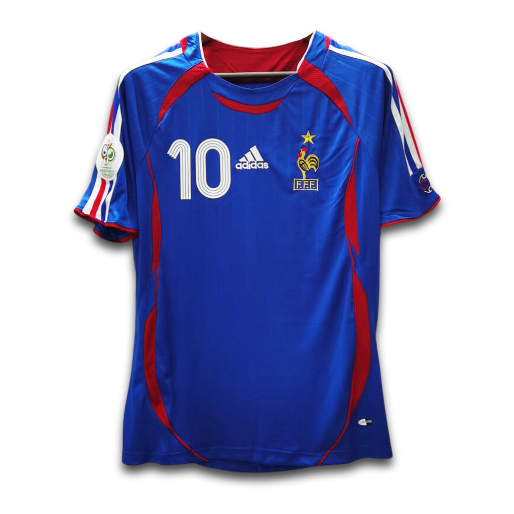 A blue soccer jersey with red and white accents, featuring the number 10 and Adidas branding, on a white background.