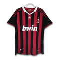 A soccer jersey with red and black stripes, featuring the Bwin sponsor logo and Adidas branding.