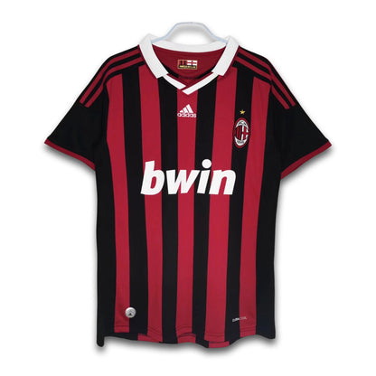 A soccer jersey with red and black stripes, featuring the Bwin sponsor logo and Adidas branding.