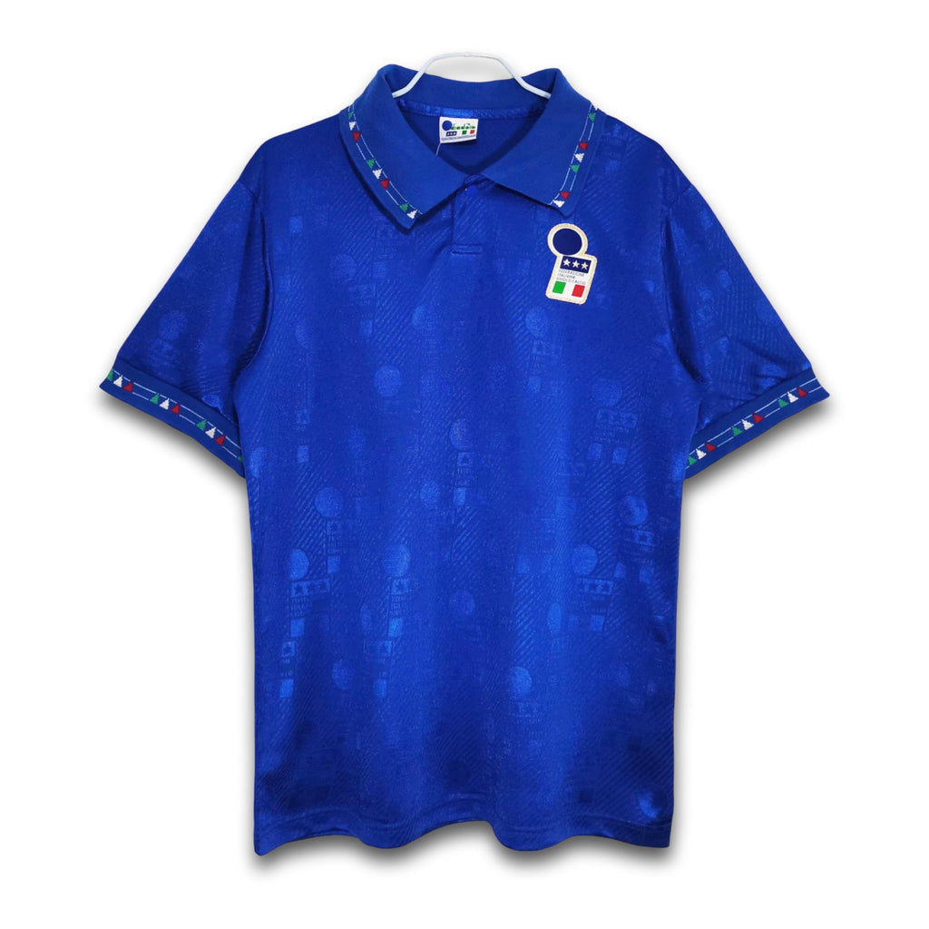 A blue soccer jersey featuring the Italy national team's design with a subtle pattern and a retro Diadora collar.