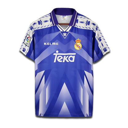A deep blue Real Madrid 1996/97 away football shirt with Teka sponsor logo and Kelme paw-print trim.