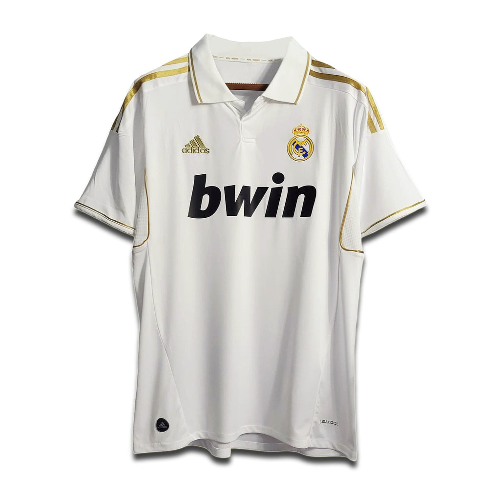 A white Real Madrid home shirt from the 2011/12 season with subtle gold trim and the Bwin sponsor logo.