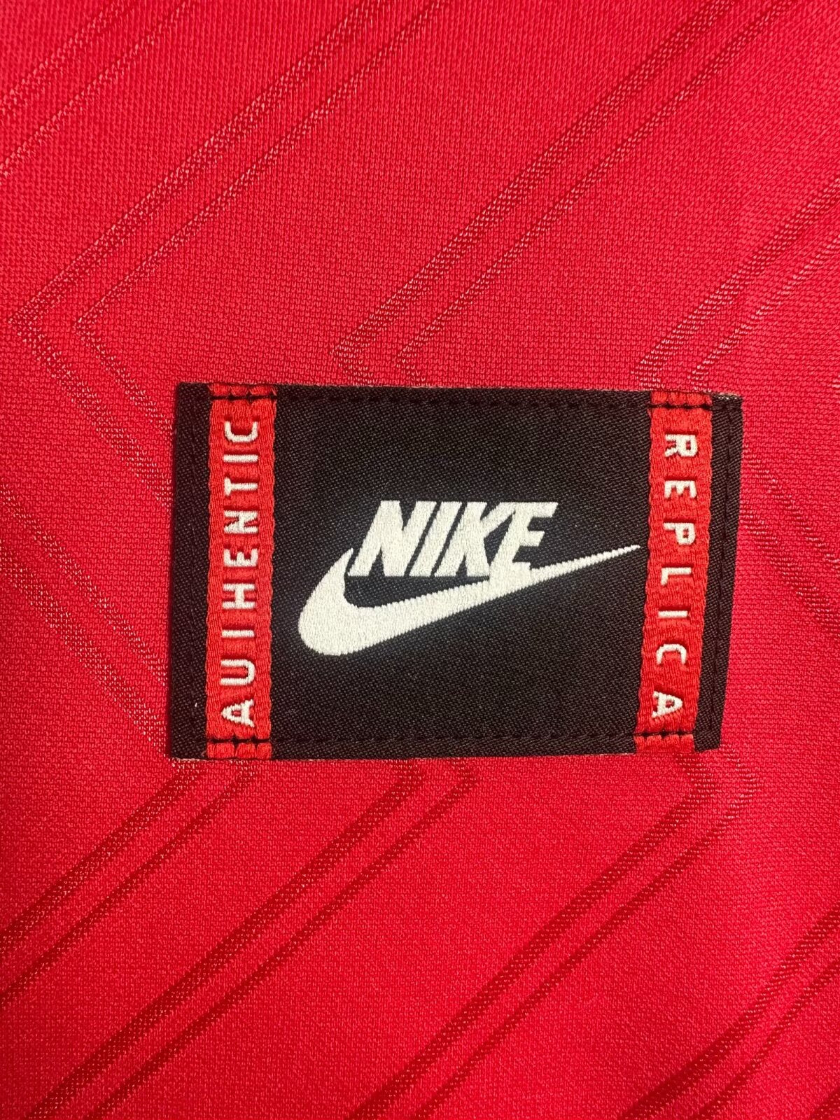 Close-up of a Nike label on a red background