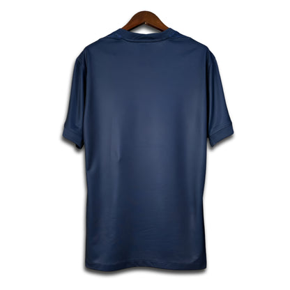 Blue Paris jersey on a wooden hanger against a white background
