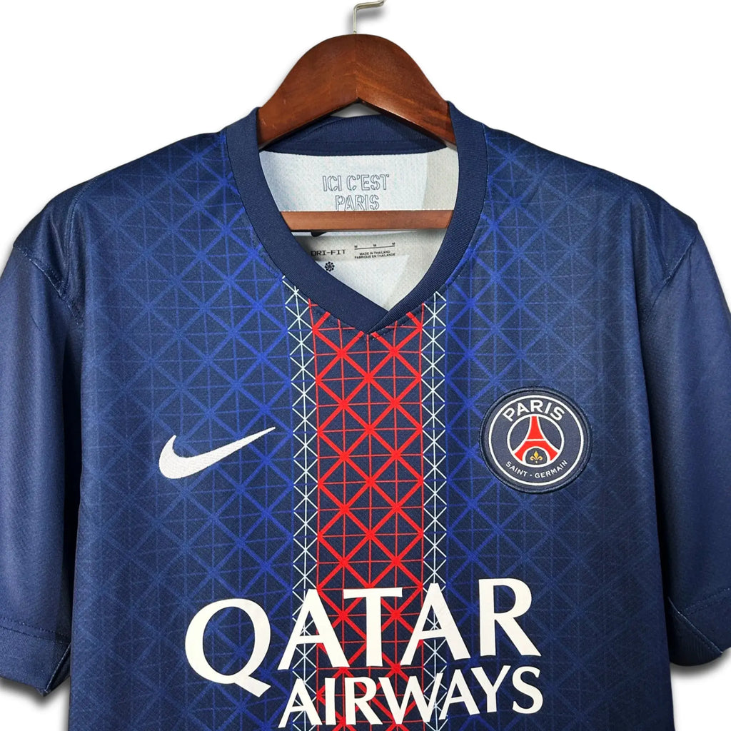 Blue Paris Saint Germain jersey with red and white pattern and 'Qatar Airways' branding on a hanger.