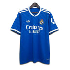 Blue Real Madrid jersey with visible Emirates and Adidas branding on a white background
