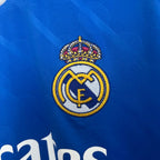 Close-up of Real Madrid logo on a blue sports jersey