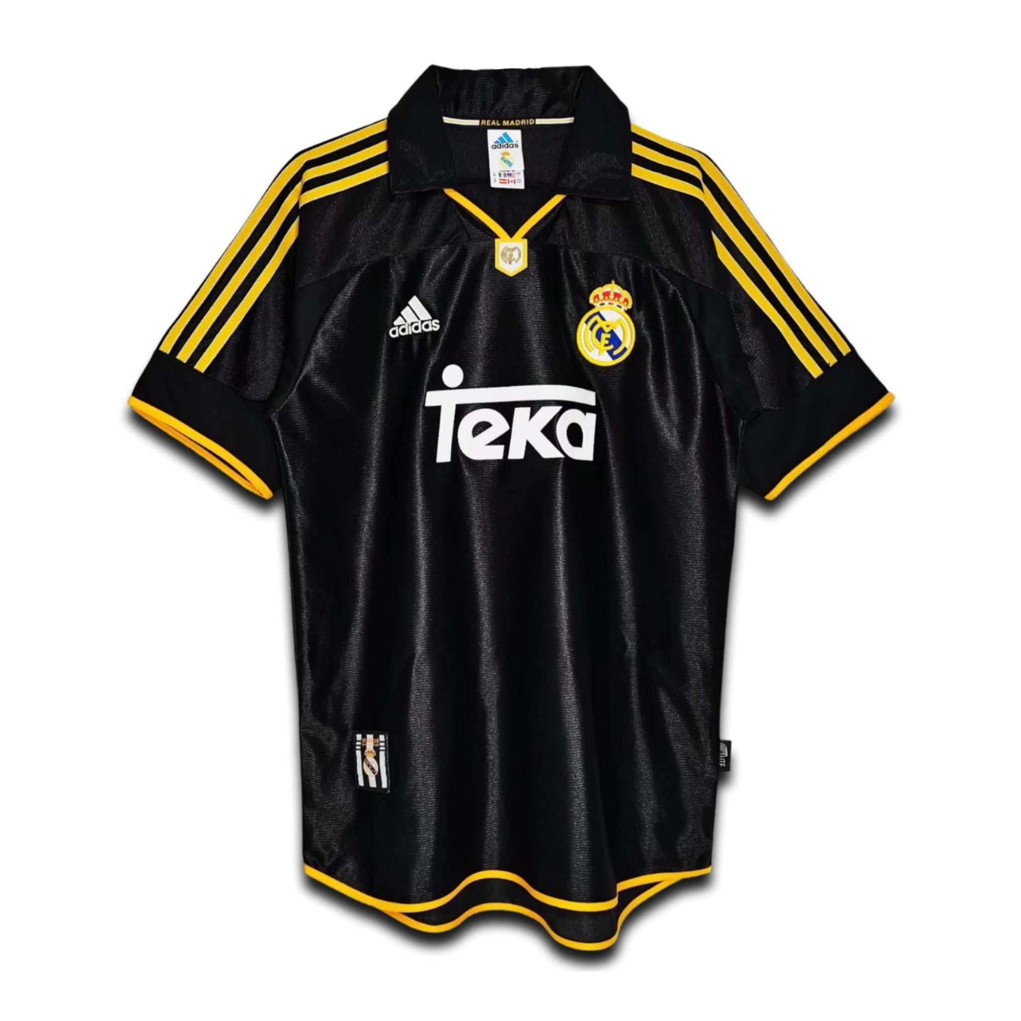 A black and yellow Real Madrid away retro jersey from the 1999/2000 season with the Teka sponsor logo, Adidas branding, and the Real Madrid crest.