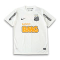 A white Nike Santos FC soccer jersey with black and yellow accents, featuring the 'Netshoes' sponsor logo on the sleeves, 'Banco BMG' on the front, and the club crest on the chest.