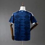 Blue sports jersey on a mannequin against a gray background