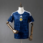 Blue sports jersey with a logo on a mannequin against a gray background