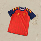Red and blue sports jersey with yellow accents on a tiled floor.