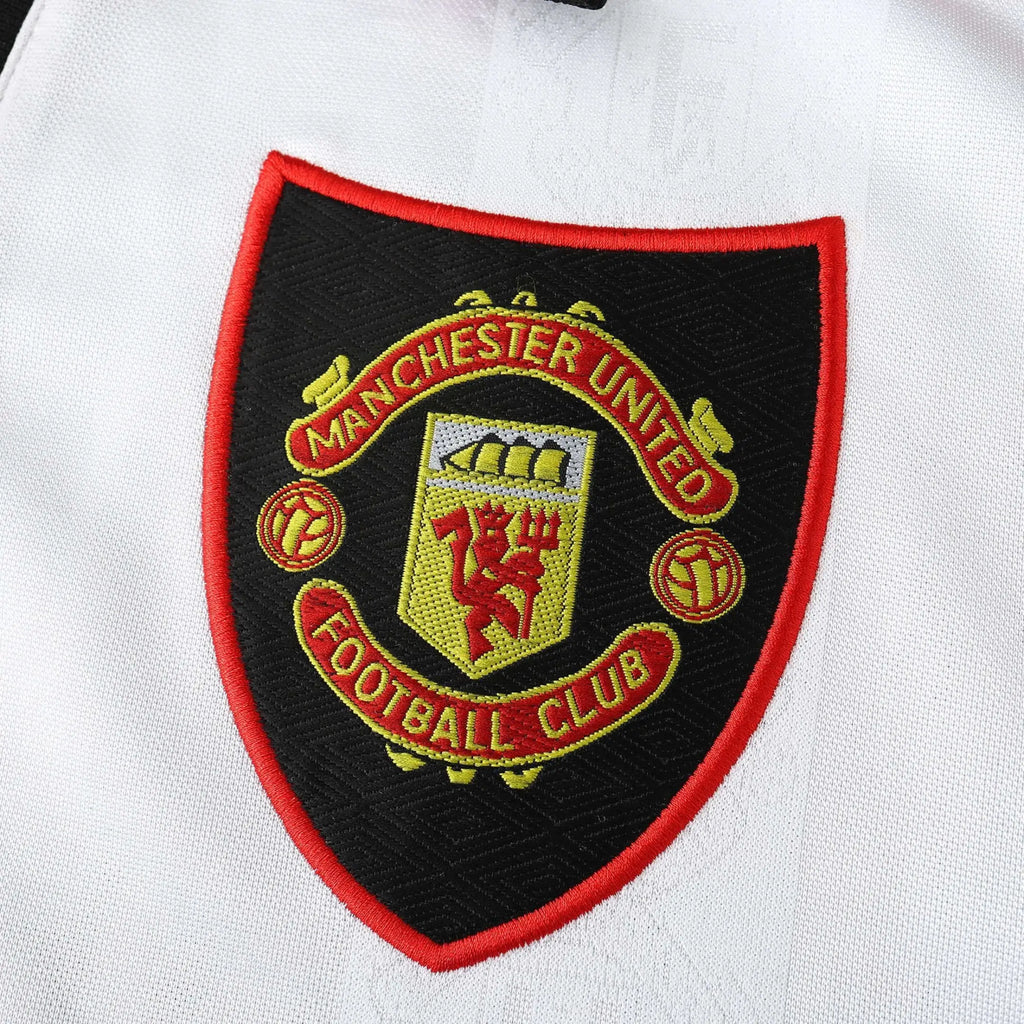 Manchester United Badge on a white shirt.