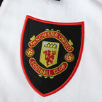 Manchester United Badge on a white shirt.